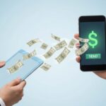 Digital transaction concept showing money being transferred between a tablet and smartphone, representing fast money transfer Oman to India.